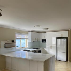 White Gloss Kitchen with Brass colour handles for a job in Rouse Hill.